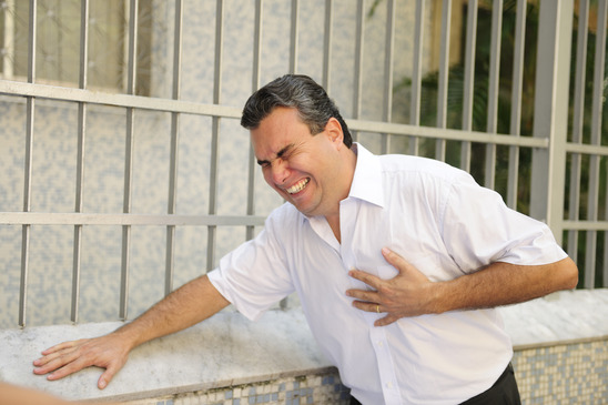 Sudden chest pain: Man having a heart attack bending
